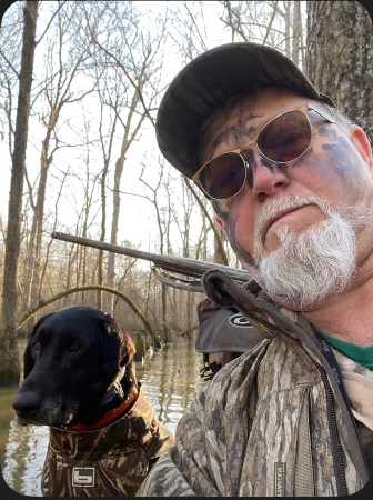 A Mallard’s Nest hunter with a retriever in flooded timber